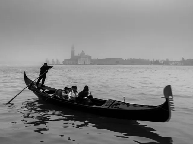A gondola travelling through a Venetian canal